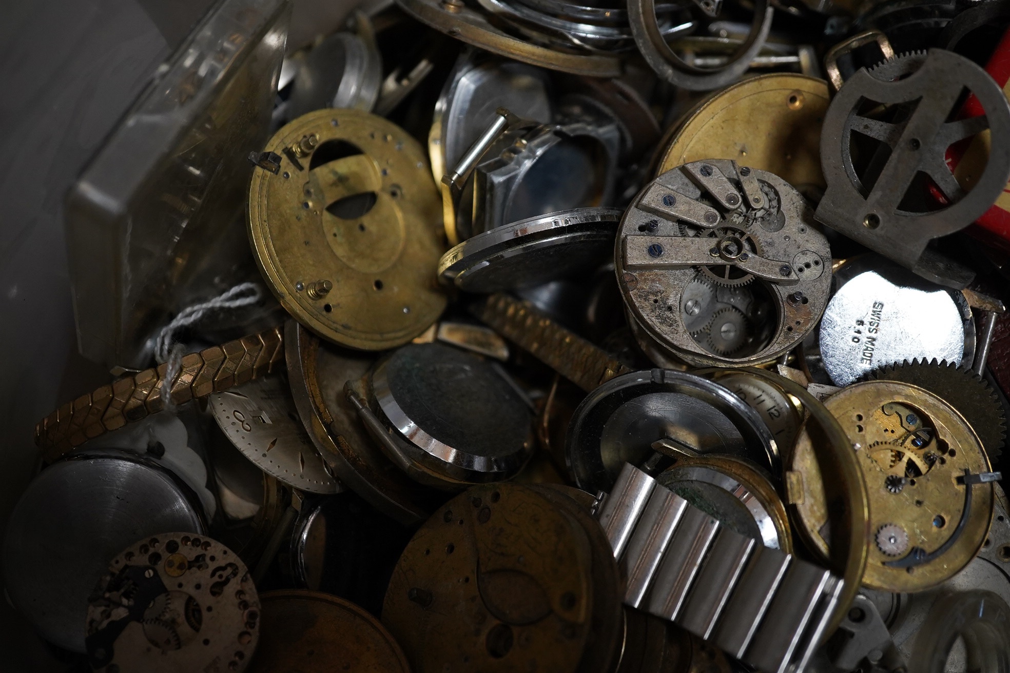 A large quantity of watch parts, spares etc from a watchmaker's studio. Condition - poor to fair